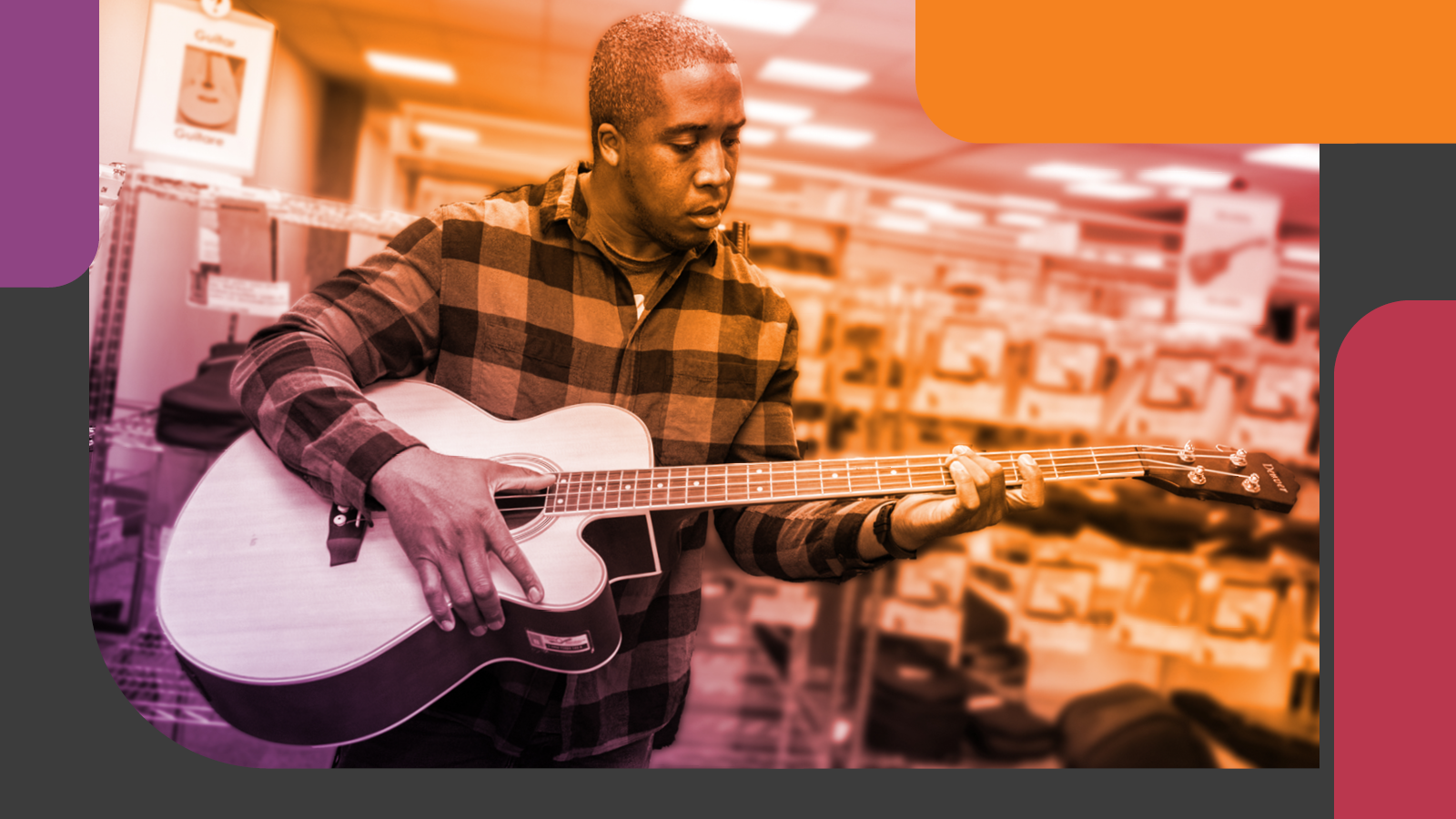 Anthony, who works in the OPL lending library, is playing an acoustic guitar
