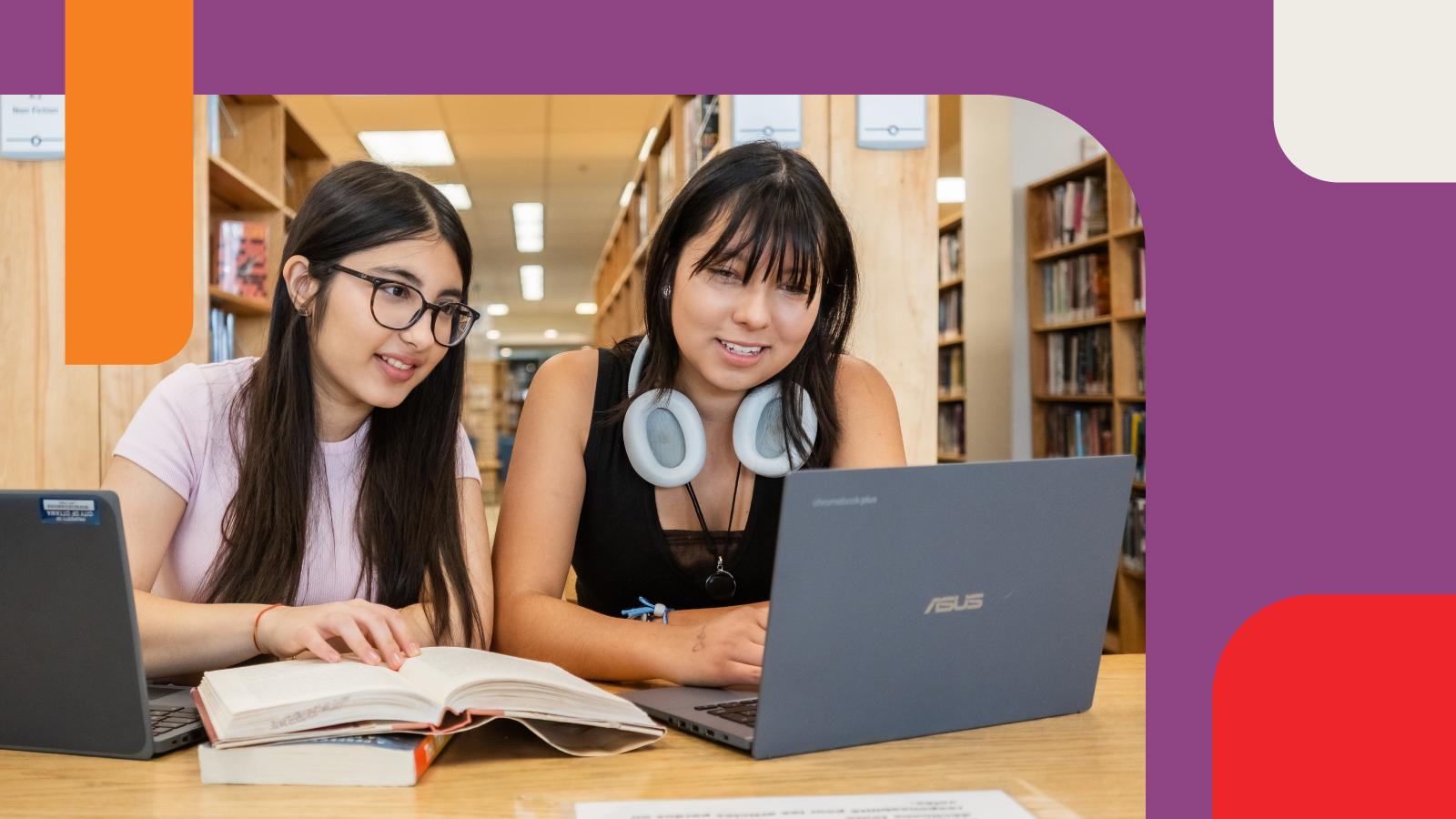 Two Teens working on a laptop at the Library