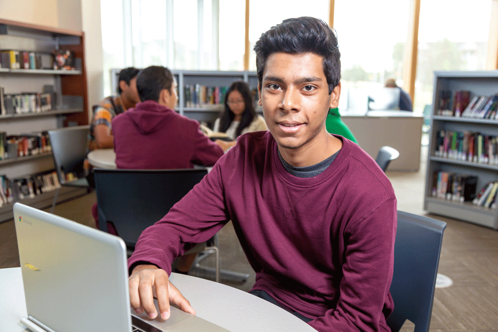 A man at a table with a laptop